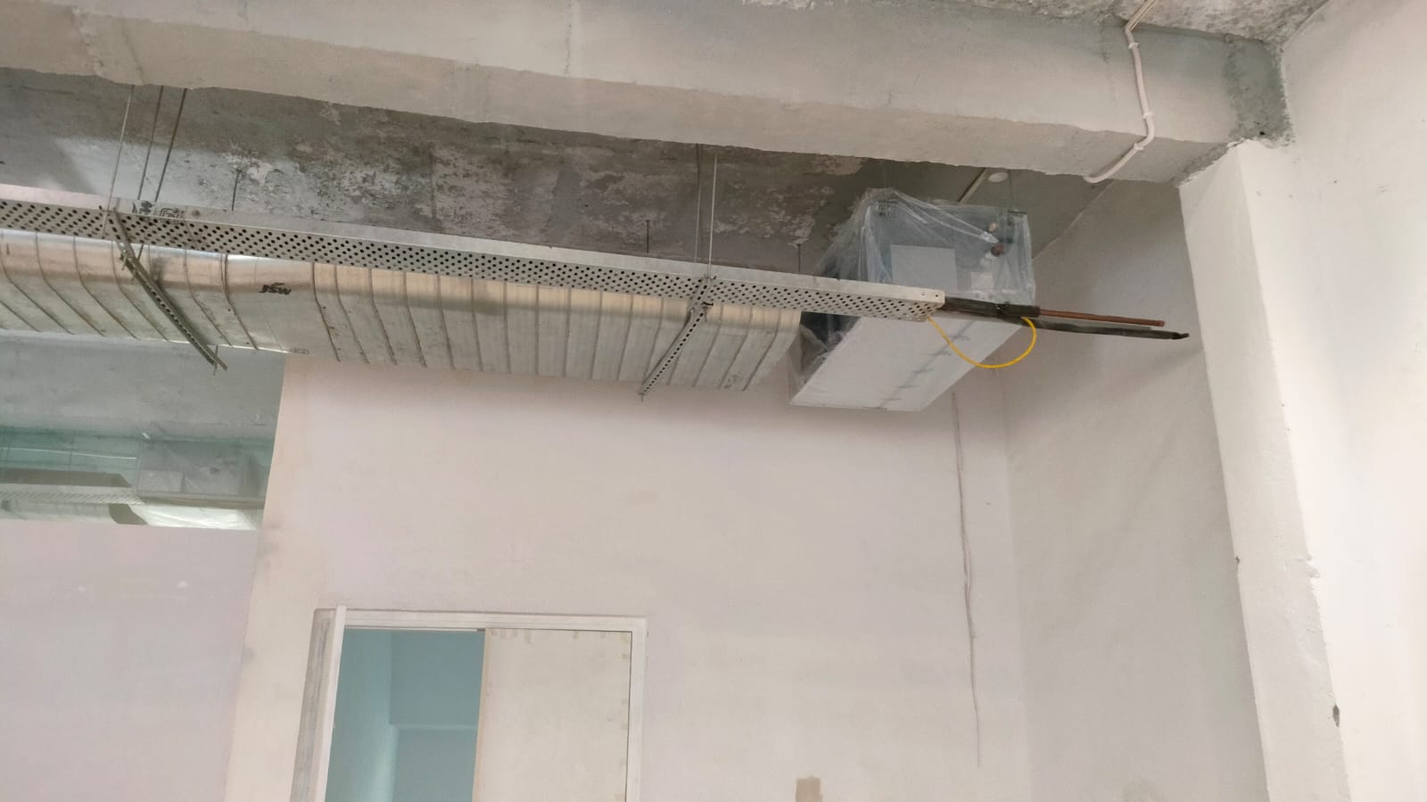 A cozy room featuring a ceiling fan and a stylish ceiling light, creating a warm and inviting atmosphere.