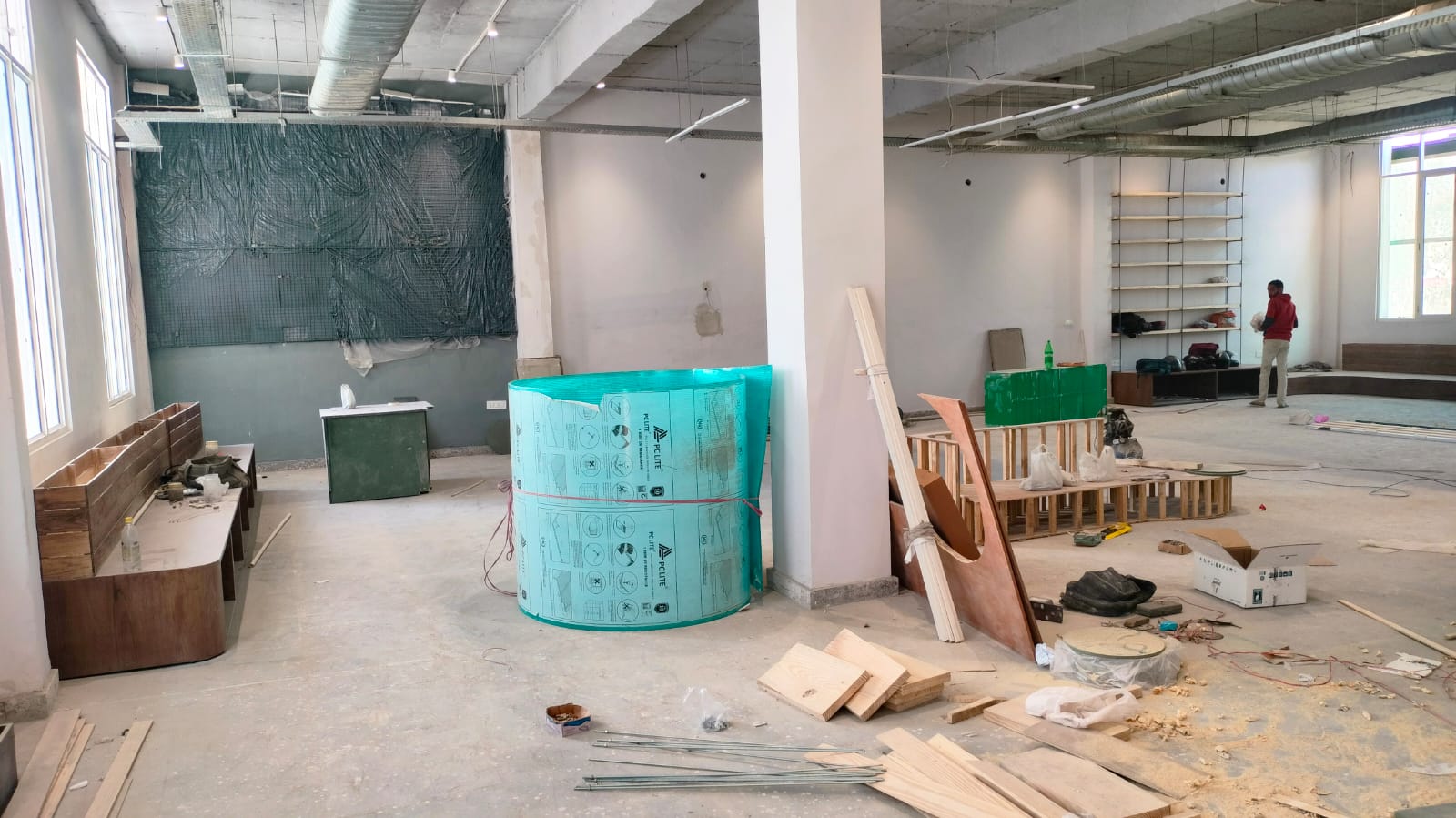 A cozy room featuring a wooden table and a vibrant green tub, creating a warm and inviting atmosphere.