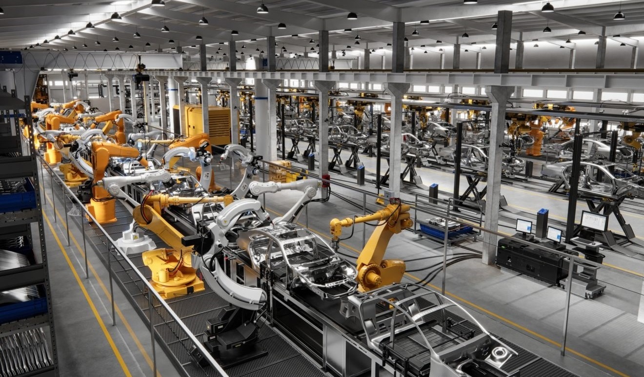 A high-tech manufacturing facility featuring multiple robotic arms assembling car frames amidst a modern industrial layout.